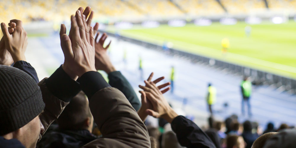 A stadium with fans cheering.